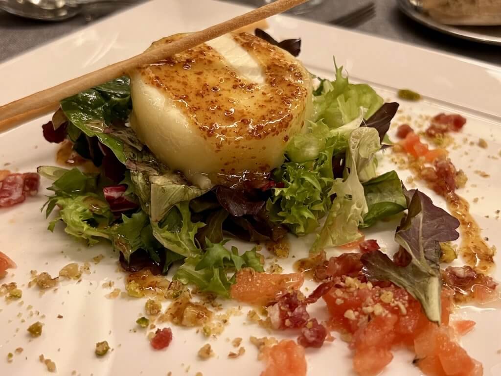 Ensalada de queso de cabra gratinado con virutas de jamón y vinagreta de miel y mostaza